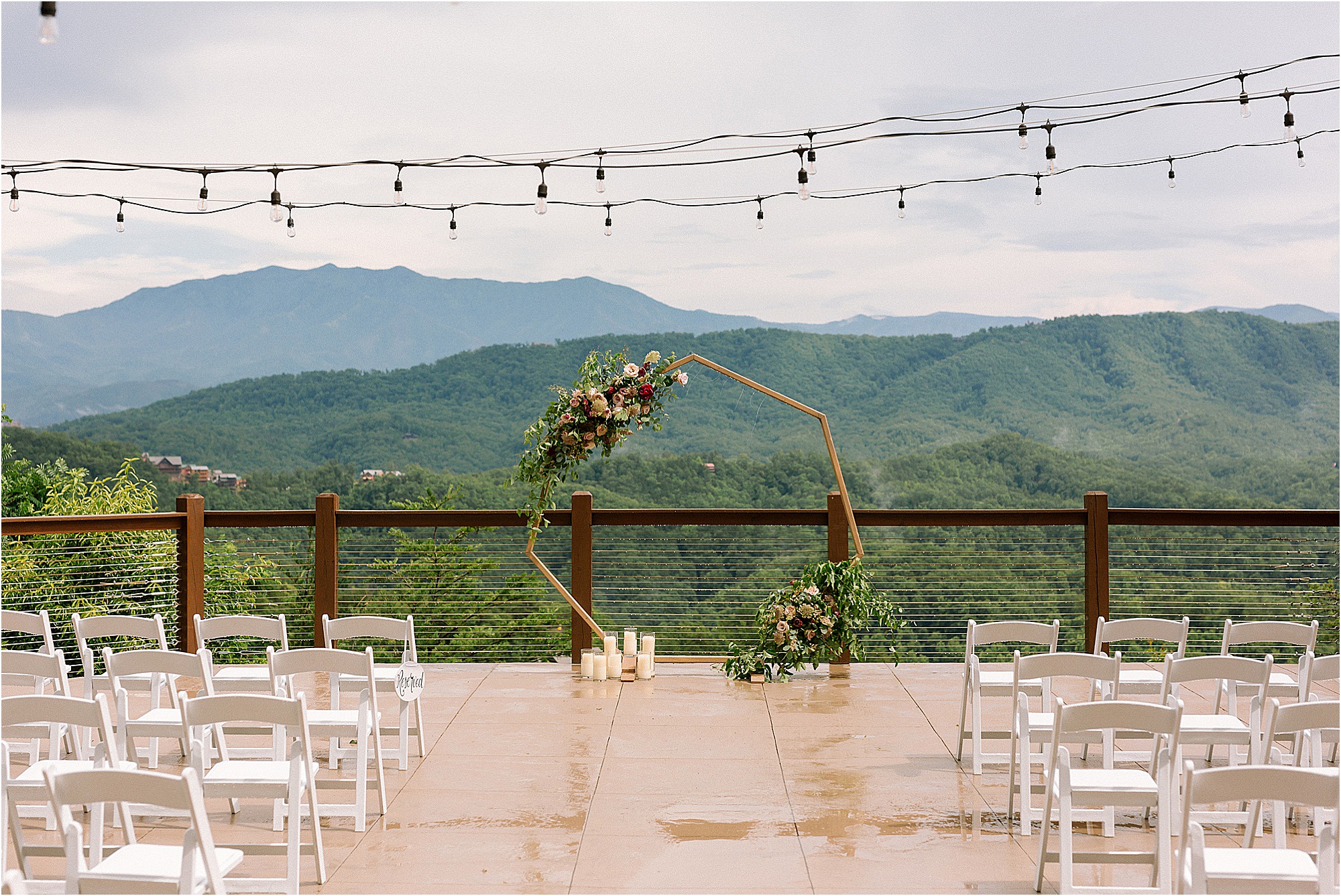 geometric wedding arbor with pink flowers