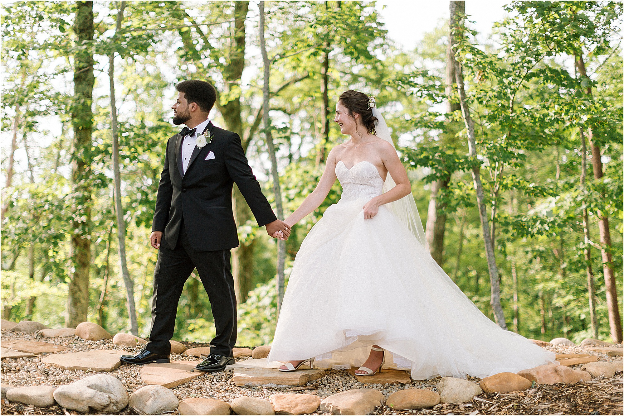 groom leads bride along path on mountaintop