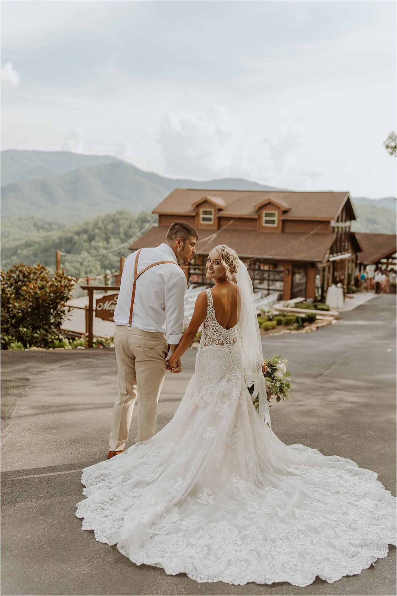 bride and groom standing in front of mountain wedding venue