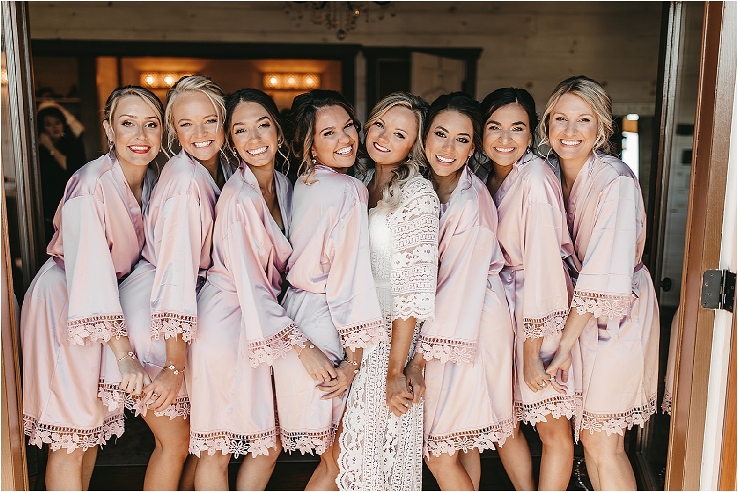 bride and bridesmaids in pink robes