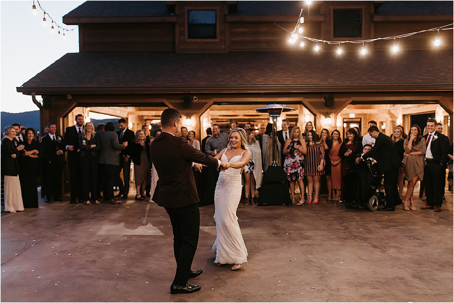 bride and groom dancing on outdoor patio in the mountains