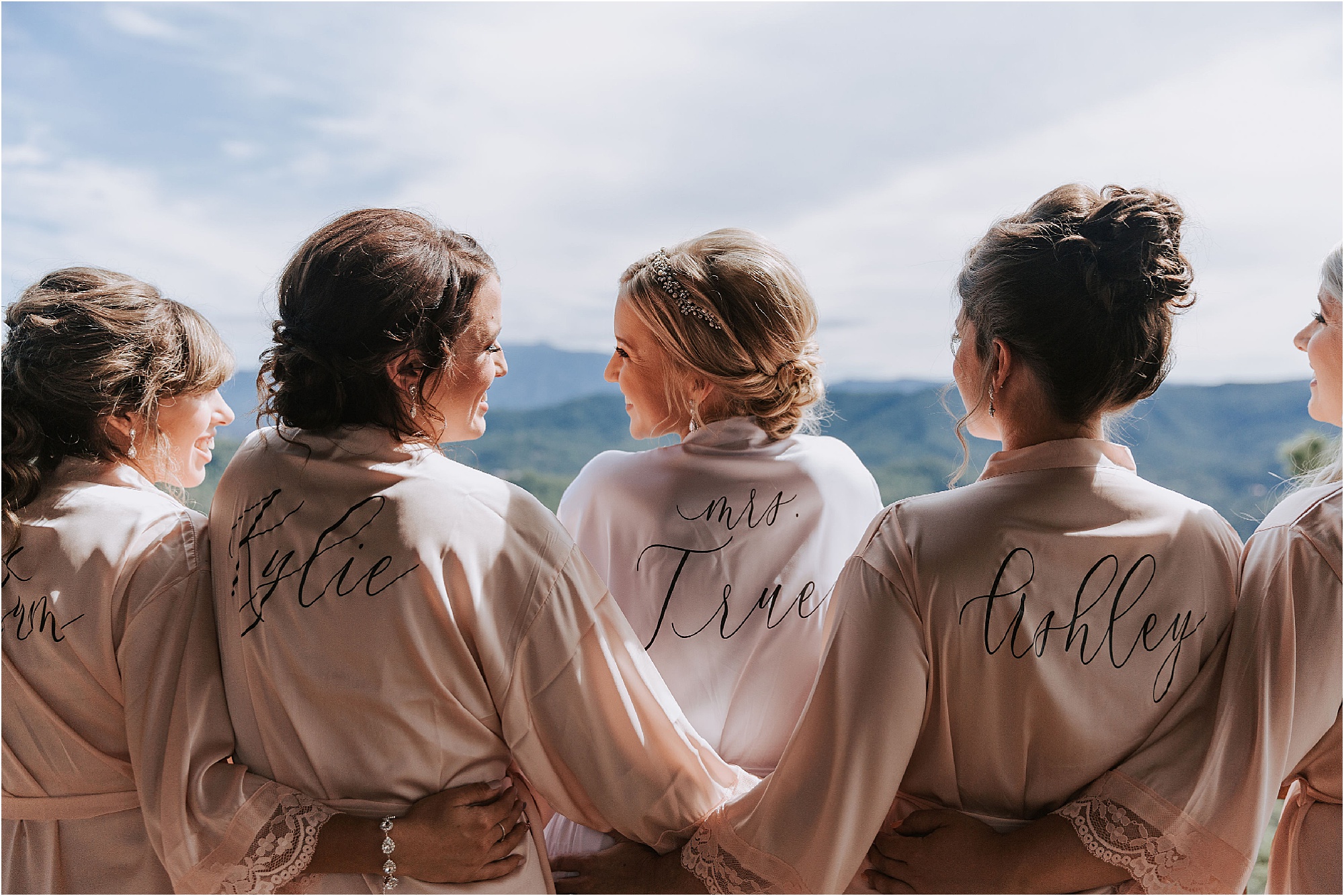 bride and bridesmaids looking over the mountain views