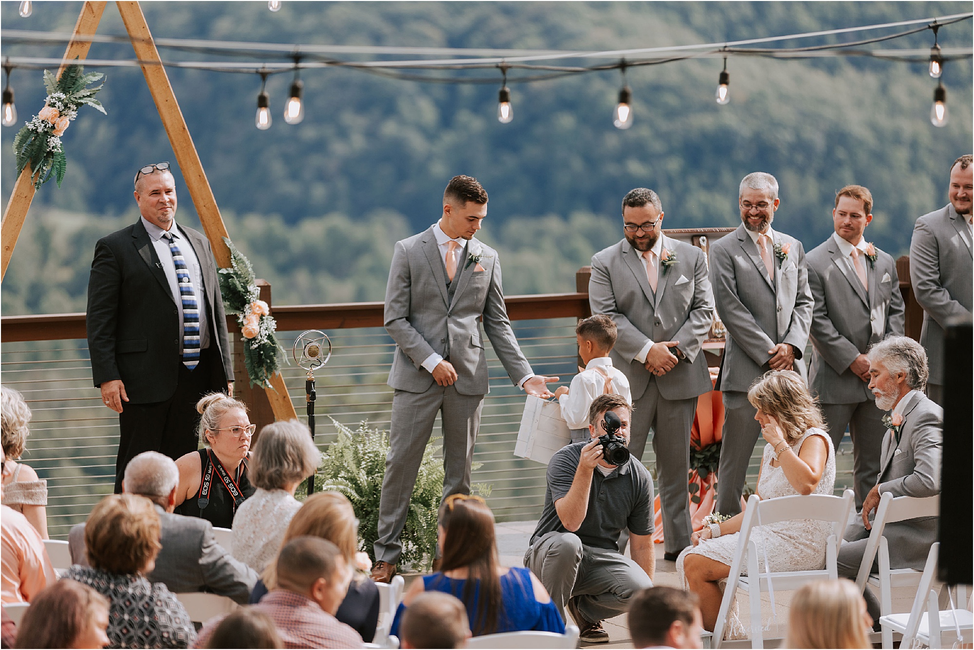 groom fist bump ring bearer at gift-giving wedding