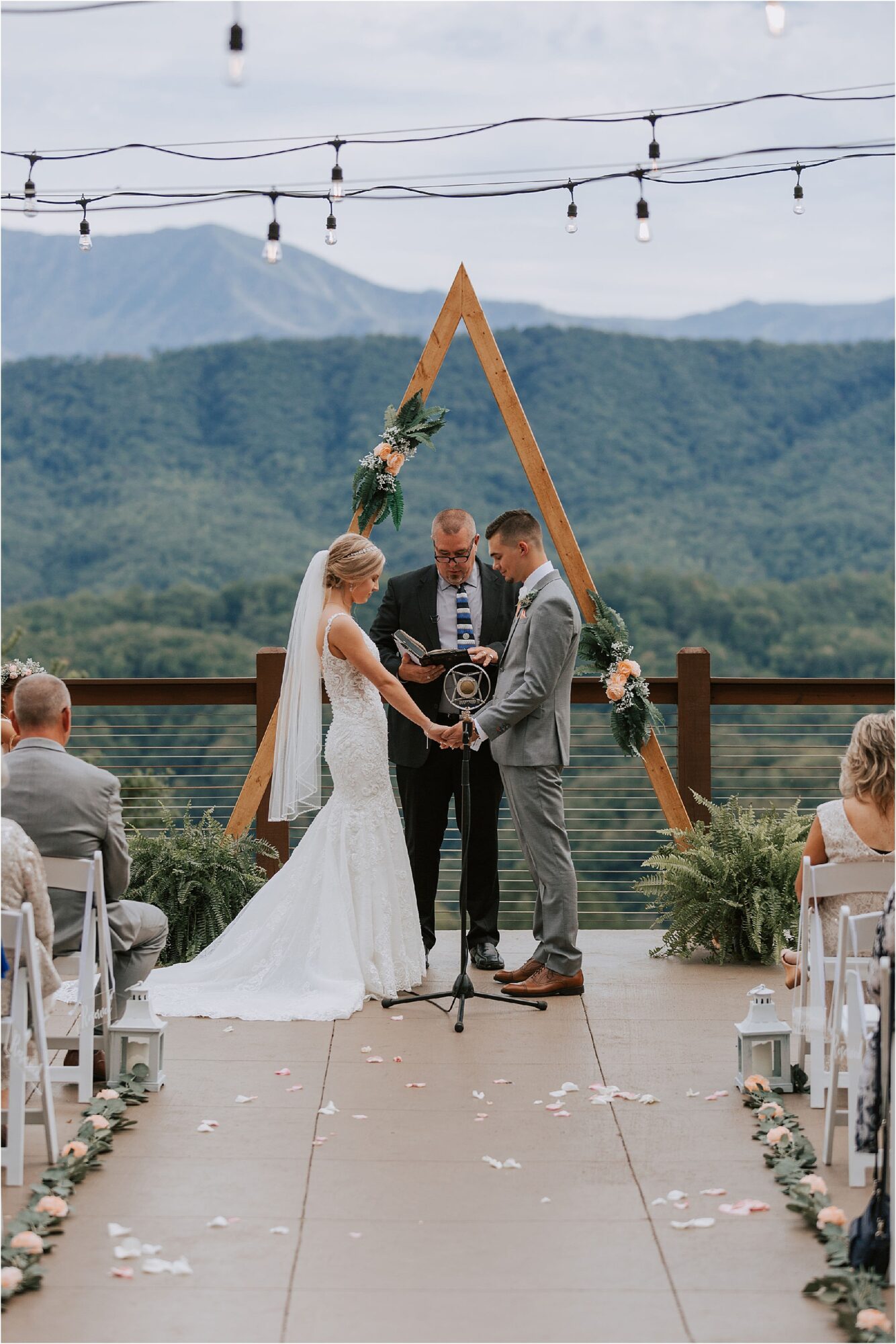 ceremony overlooking mountains with triangle wedding arbor