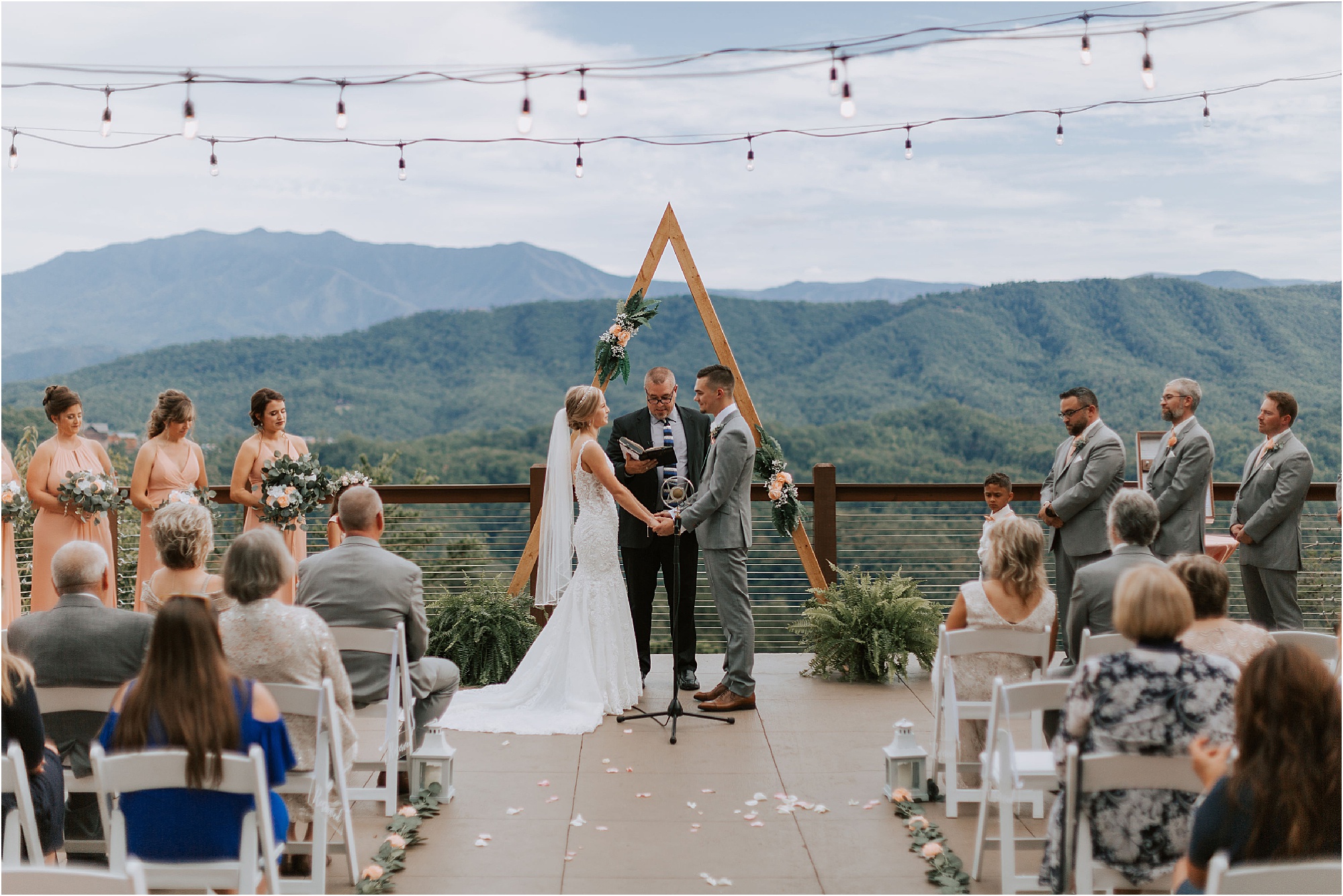 bride and groom hold hands at wedding ceremony