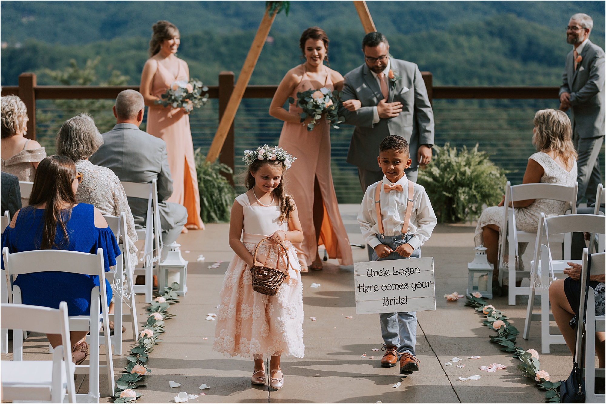 flower girl and ring bearer walk down wedding aisle