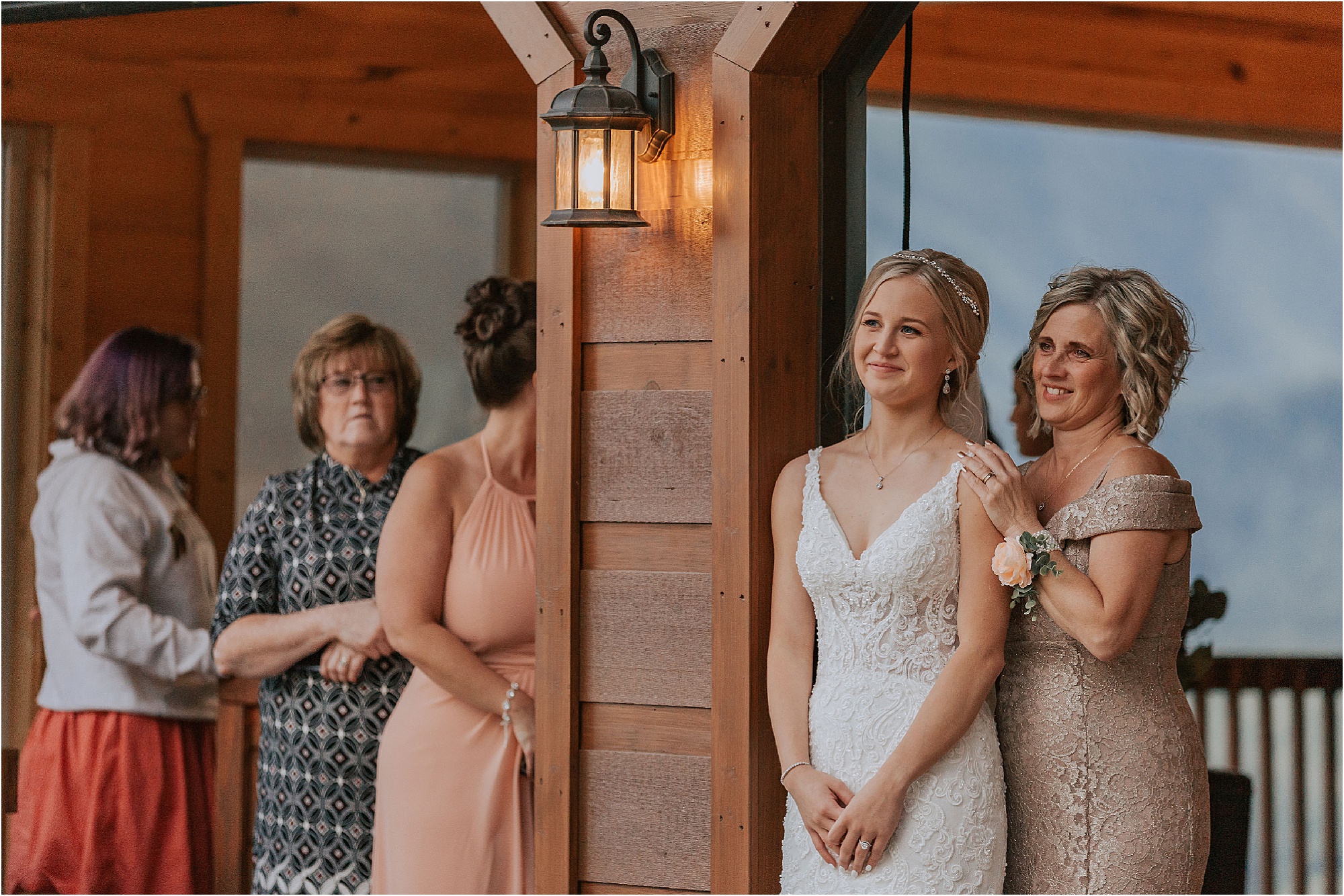 bride watches groom dance with mother