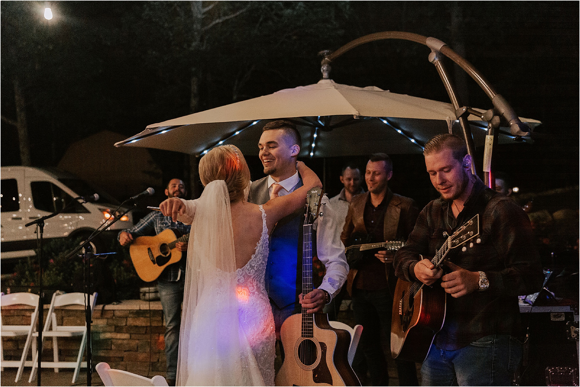 bride and groom kiss at wedding reception