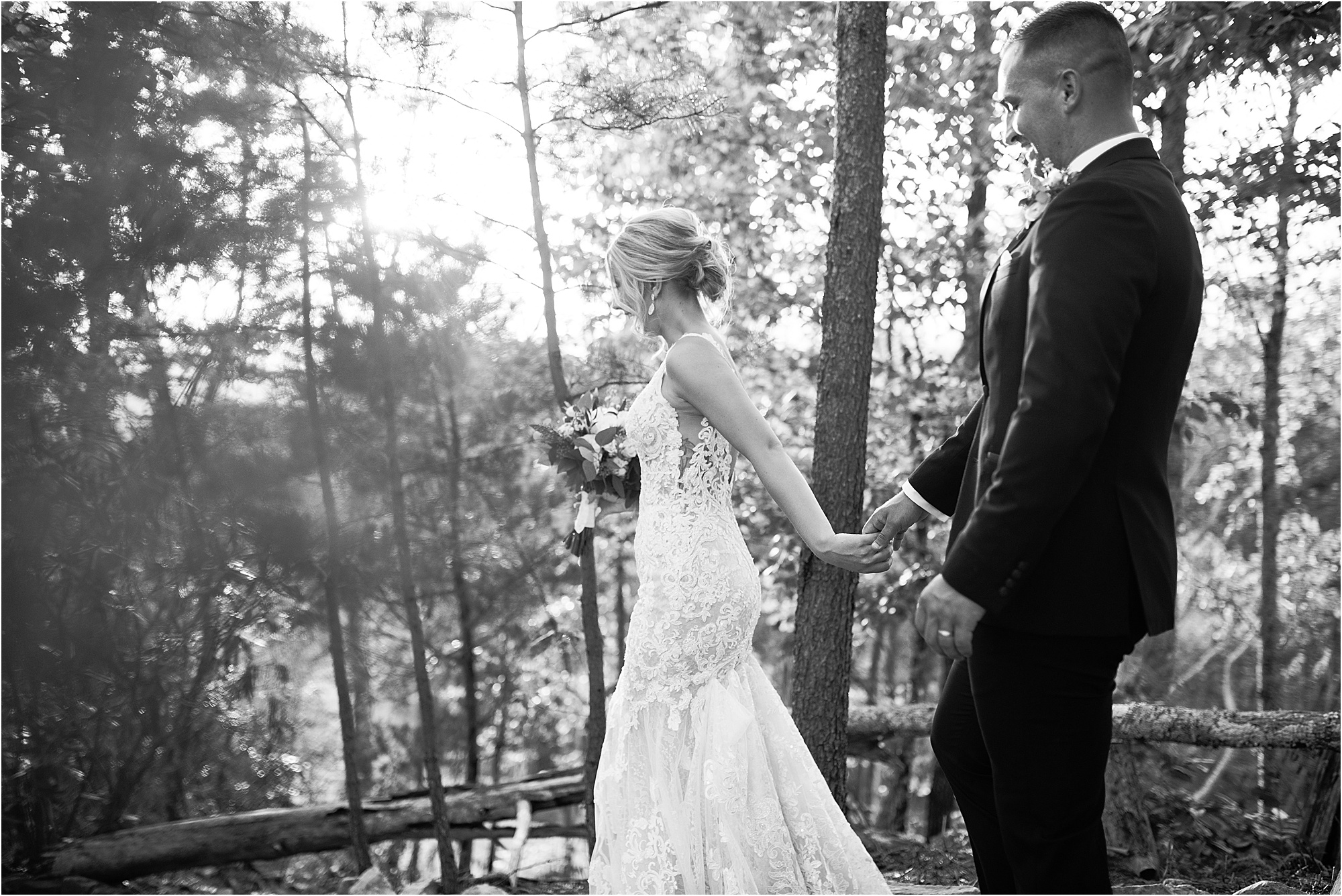 bride leads groom through forest holding hands