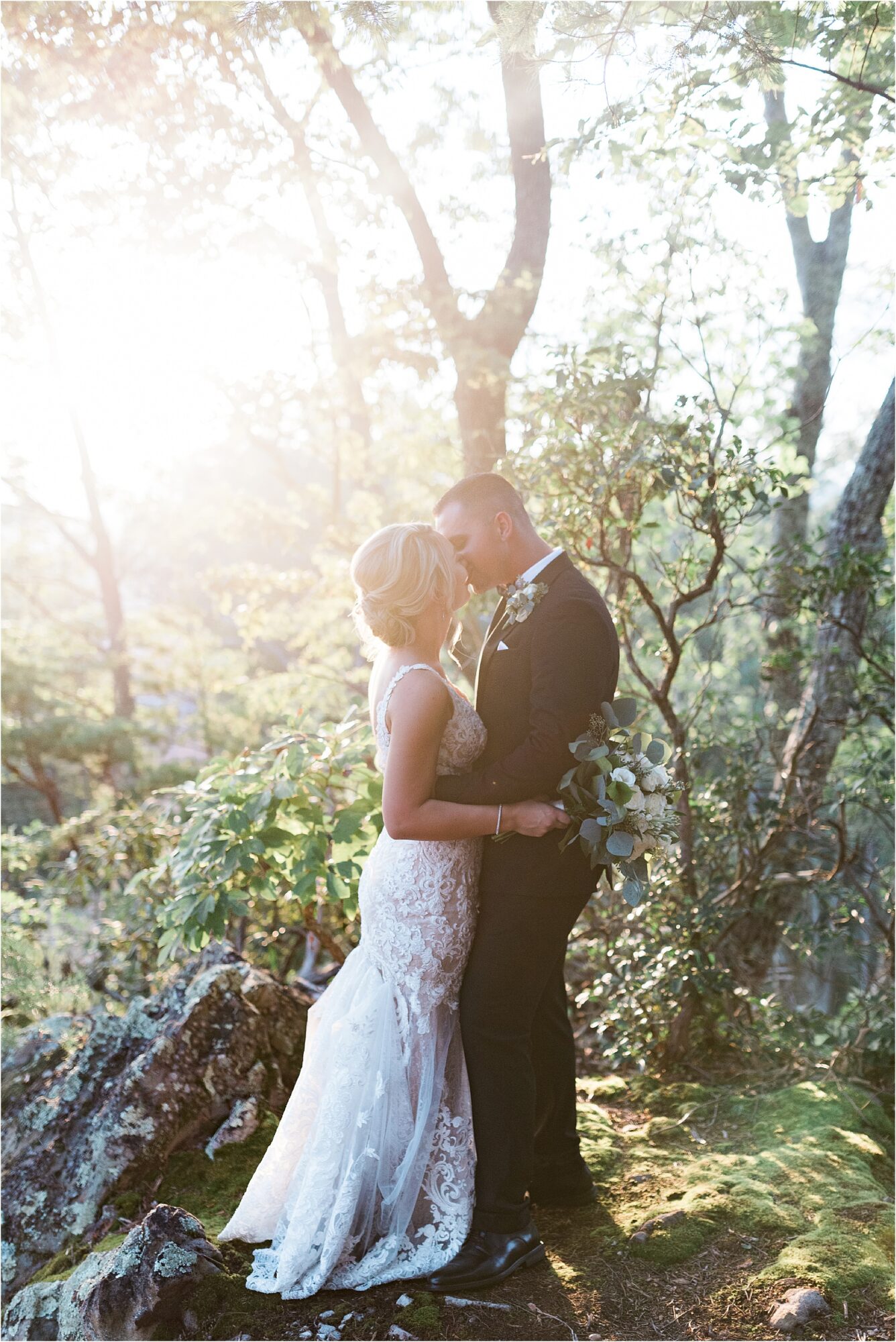 bride and groom kiss at sunset