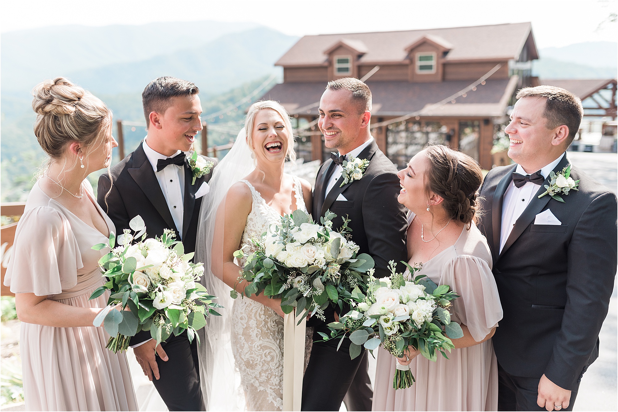 bride laughs with bridal party at Black and White Wedding