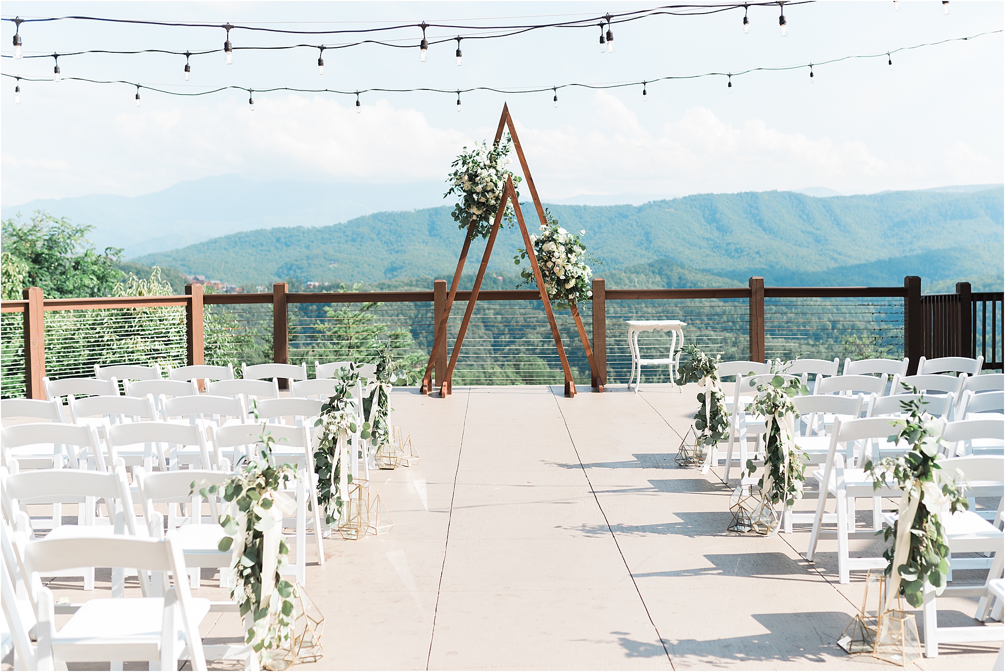 Triangle arbor ceremony backdrop overlooking mountains