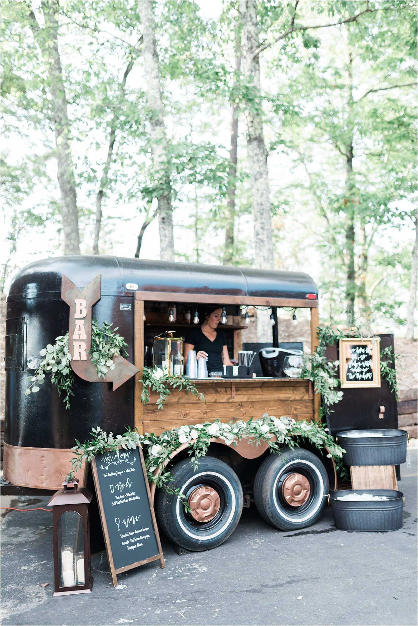 greenery on bar trailer at wedding reception by Single Barrel Events