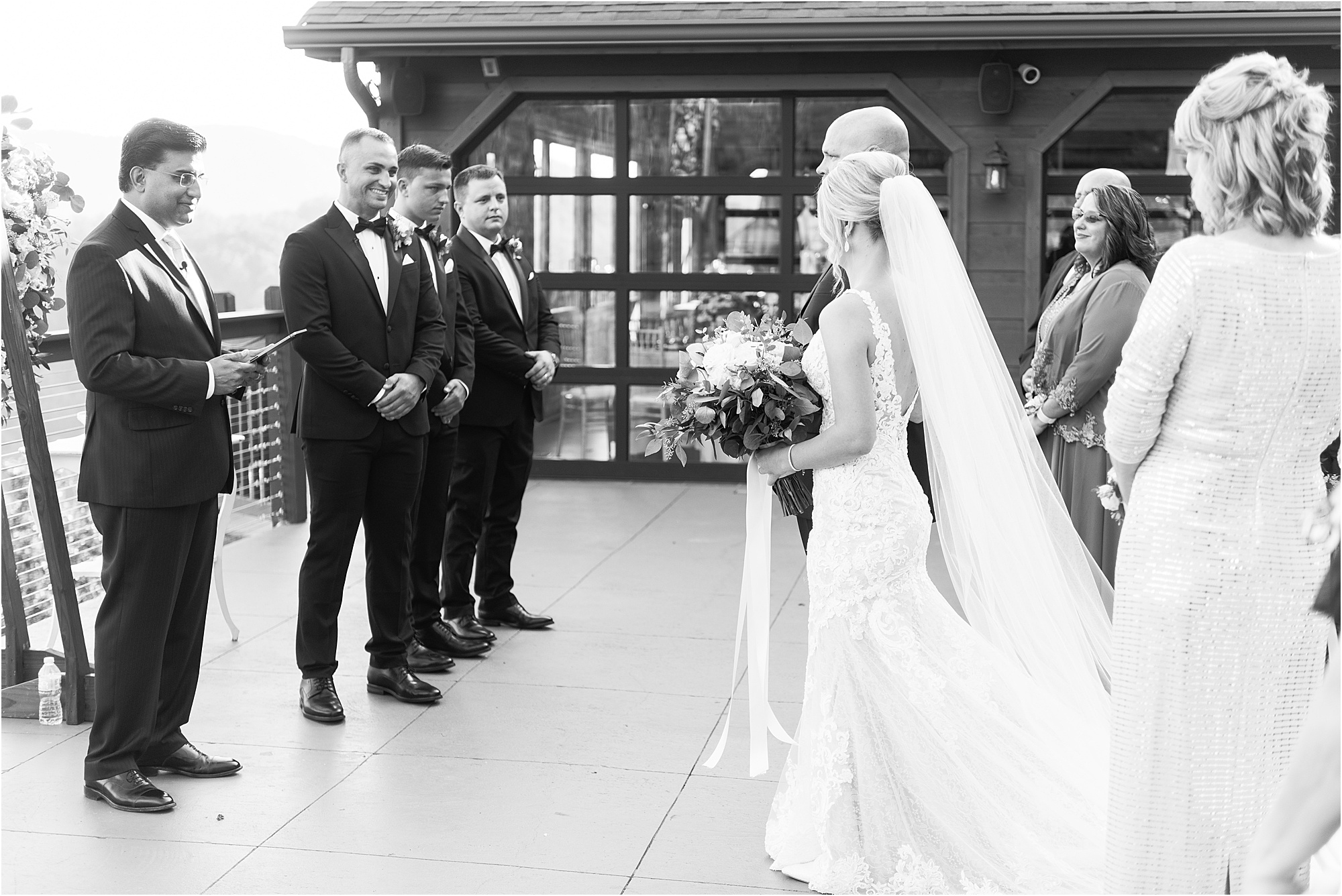 groom watching bride walk down the aisle