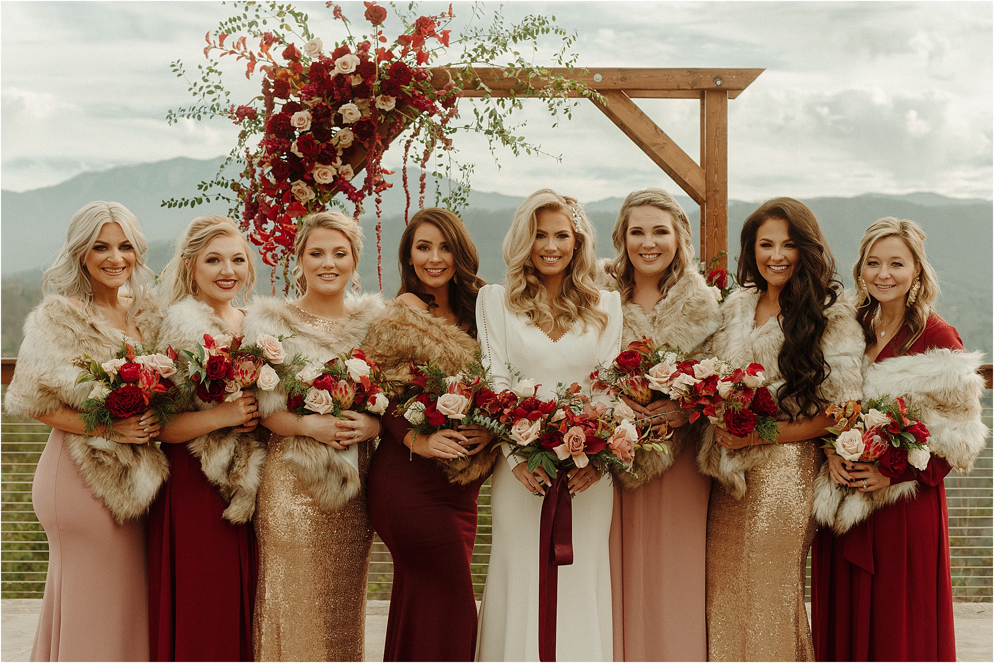 bride and bridesmaids in mismatched moody dresses