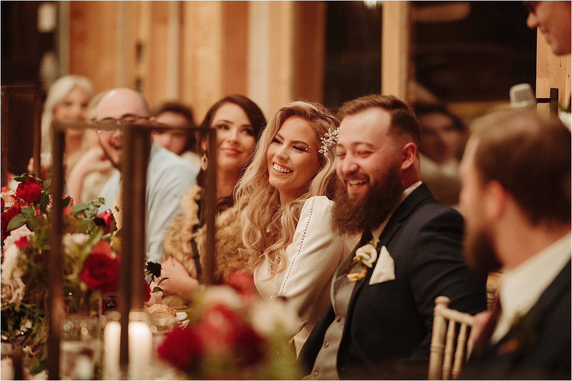 bride and groom laugh during toasts at wedding