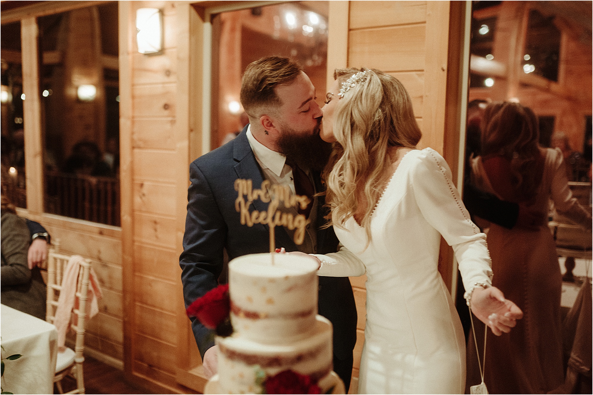 bride and groom kiss at cake cutting