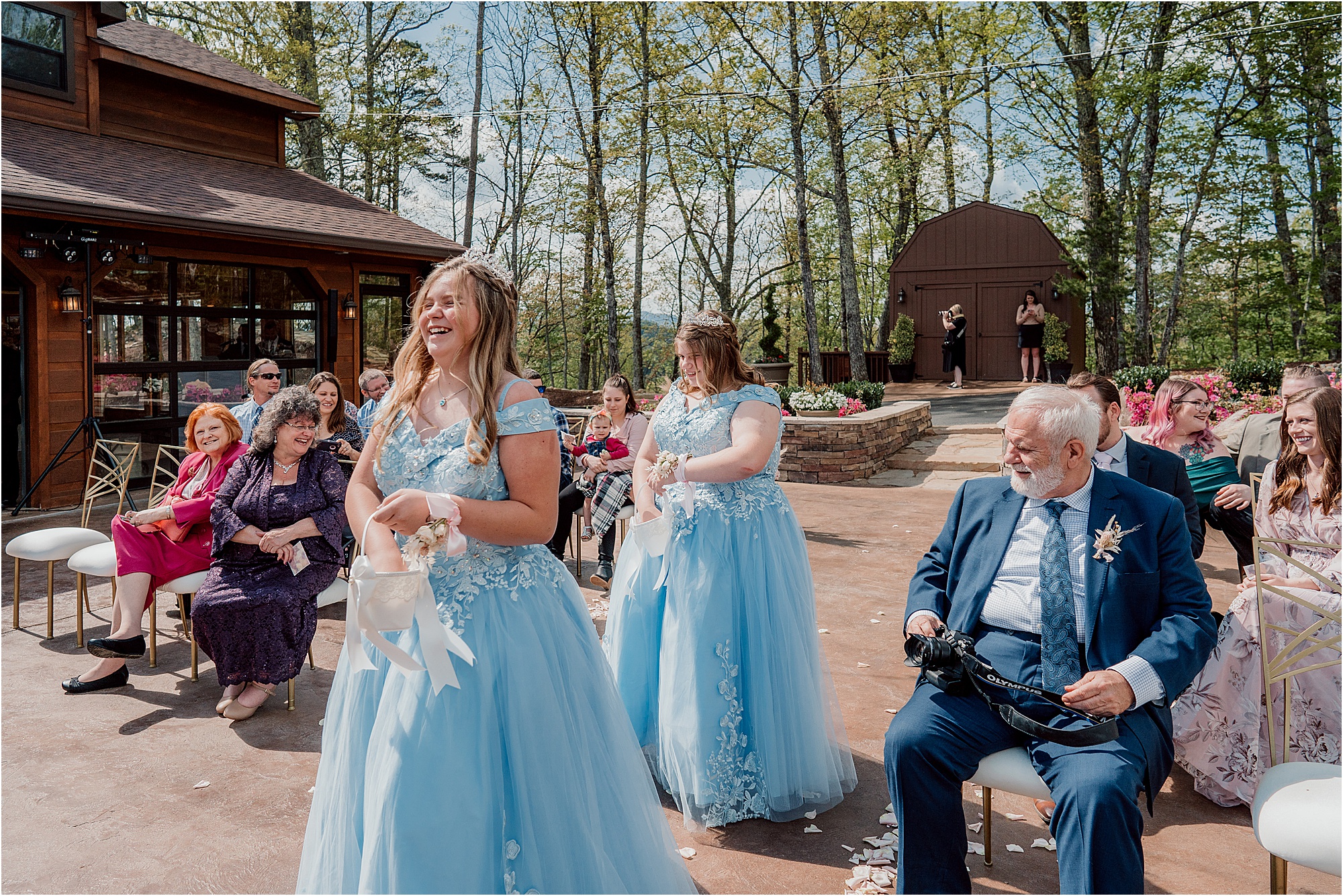 bridesmaids in blue fairytale gowns walking down wedding aisle