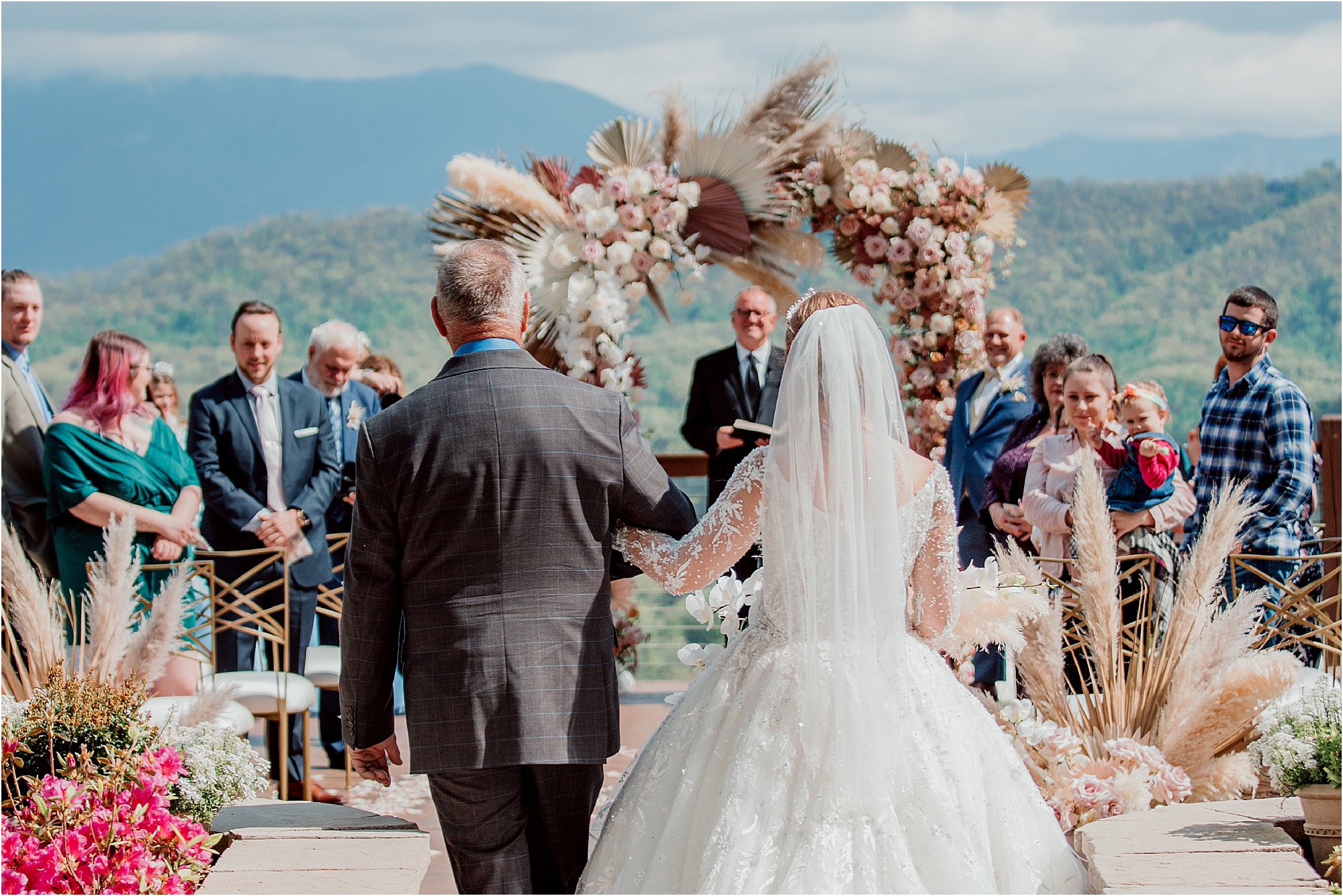 bride walking with father down wedding aisle