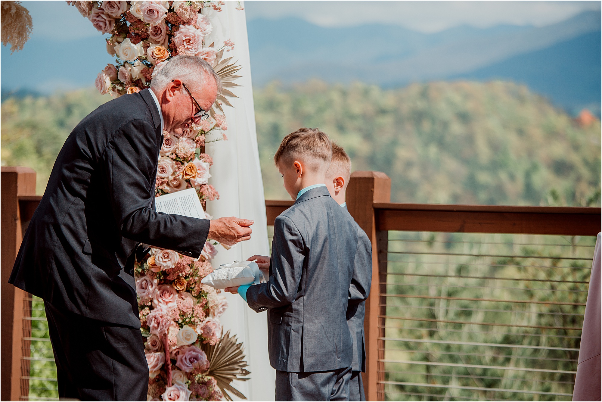 ring bearer handing officiant rings