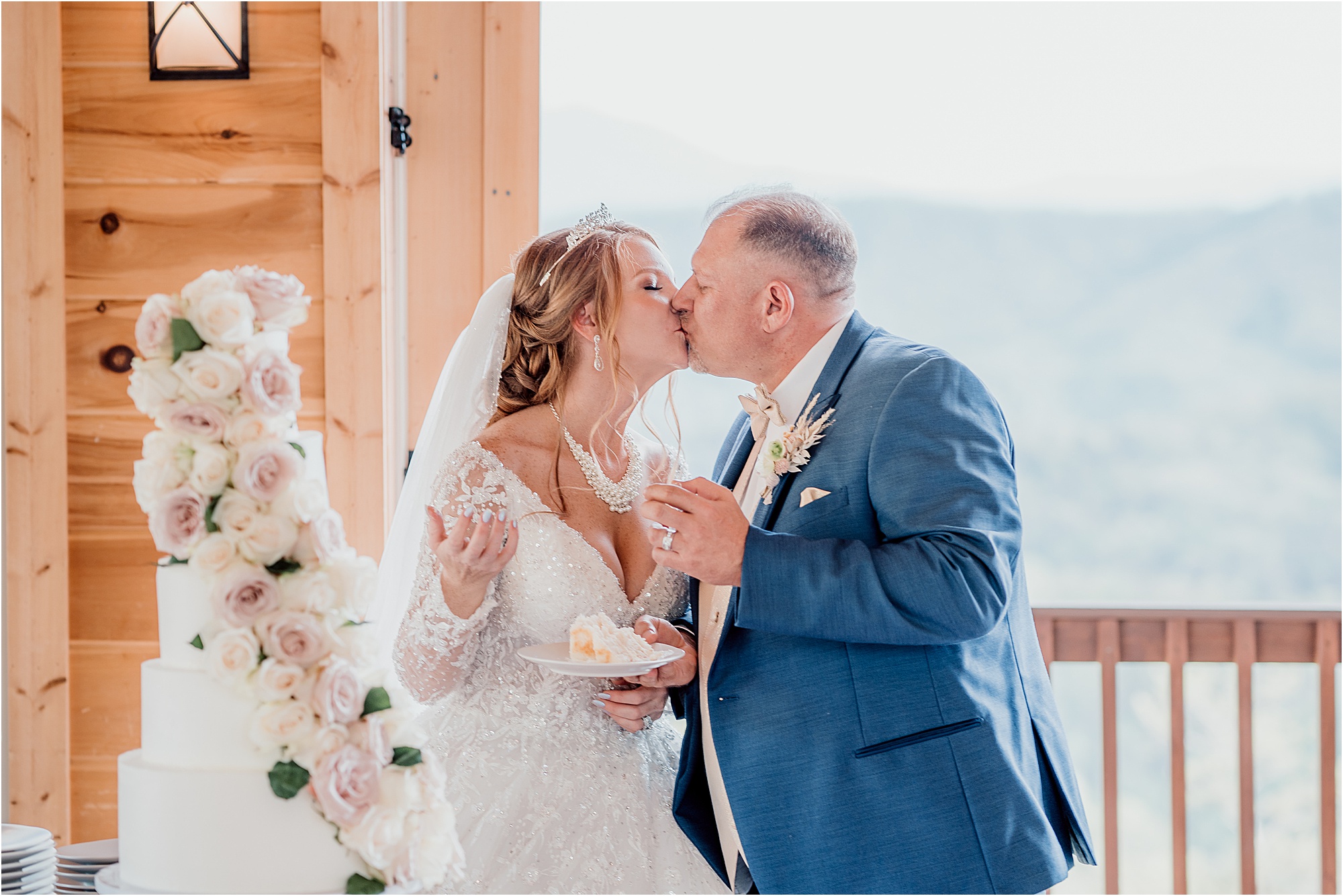 bride and groom kiss after cutting wedding cake