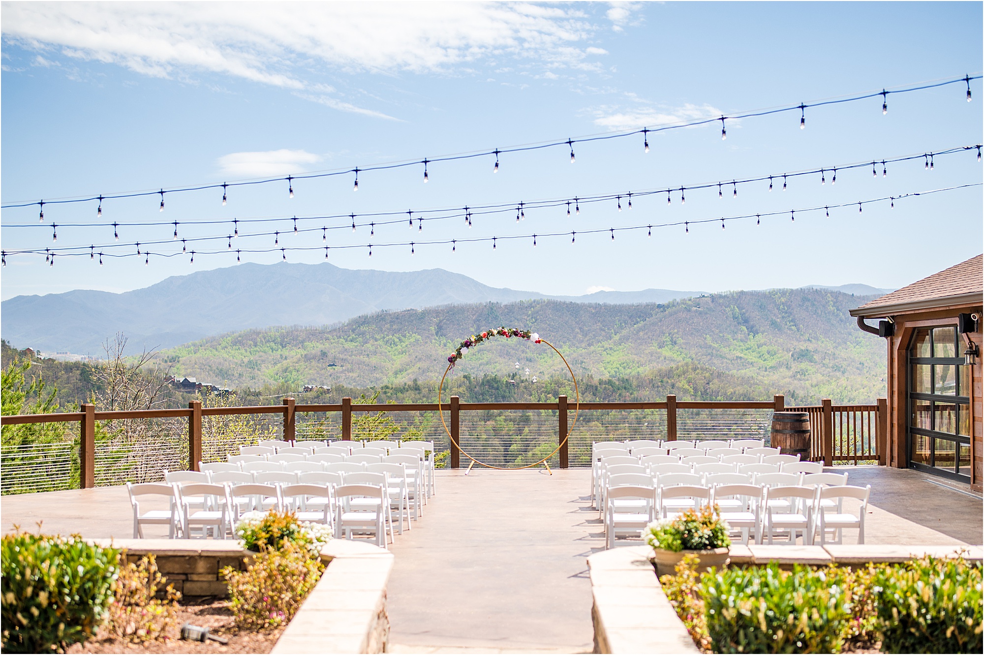 mountainside wedding ceremony with circle wedding arbor and chairs