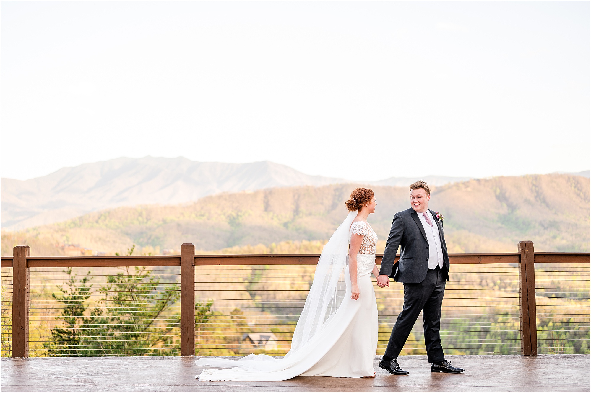 bride and groom walking on patio overlooking the Smokies