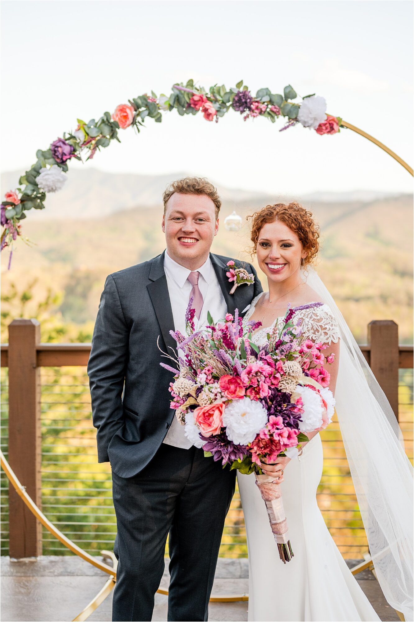 bride and groom standing in front of circle wedding arbor with floating candles