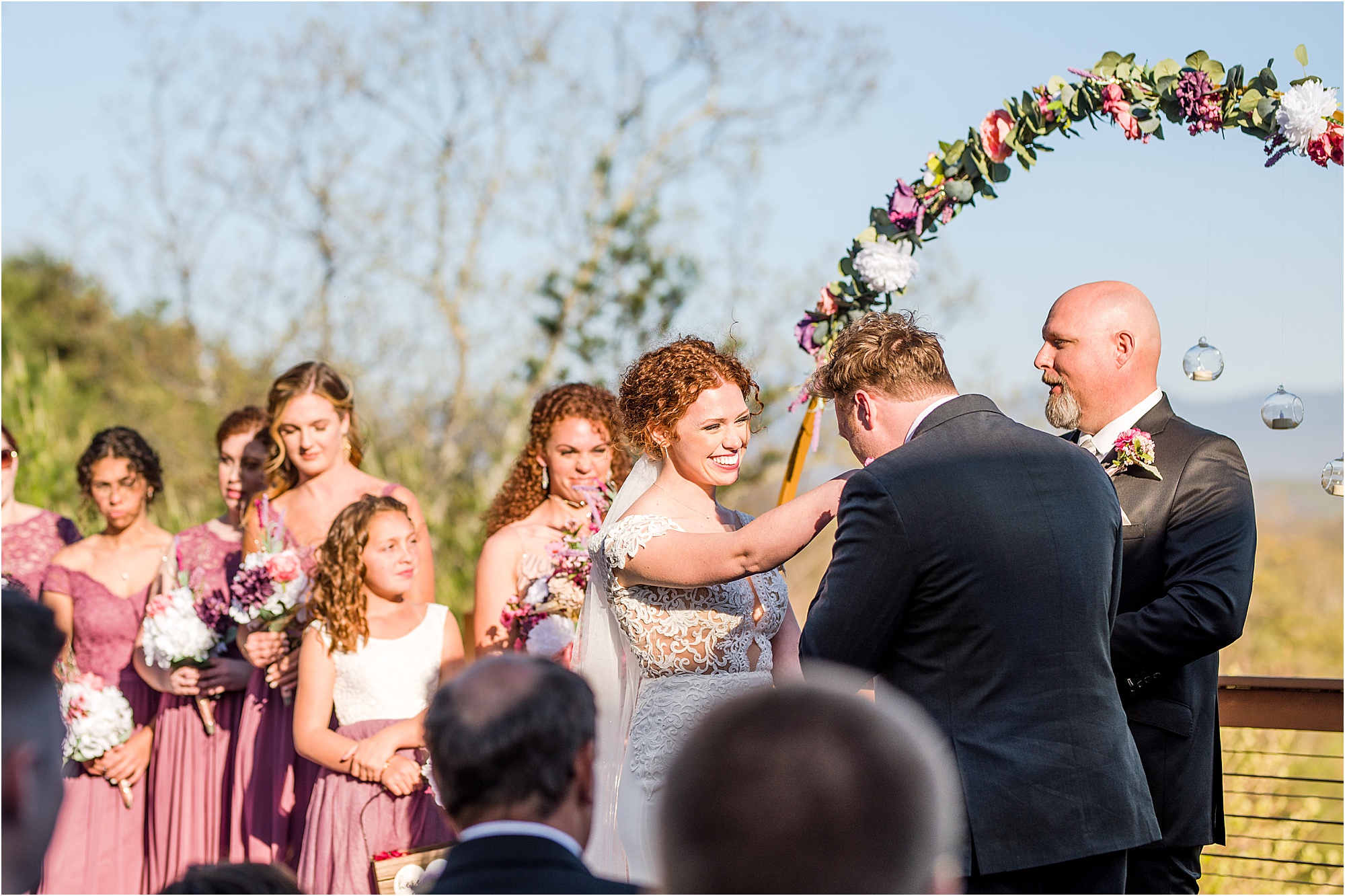 groom kisses bride's hand at wedding ceremony