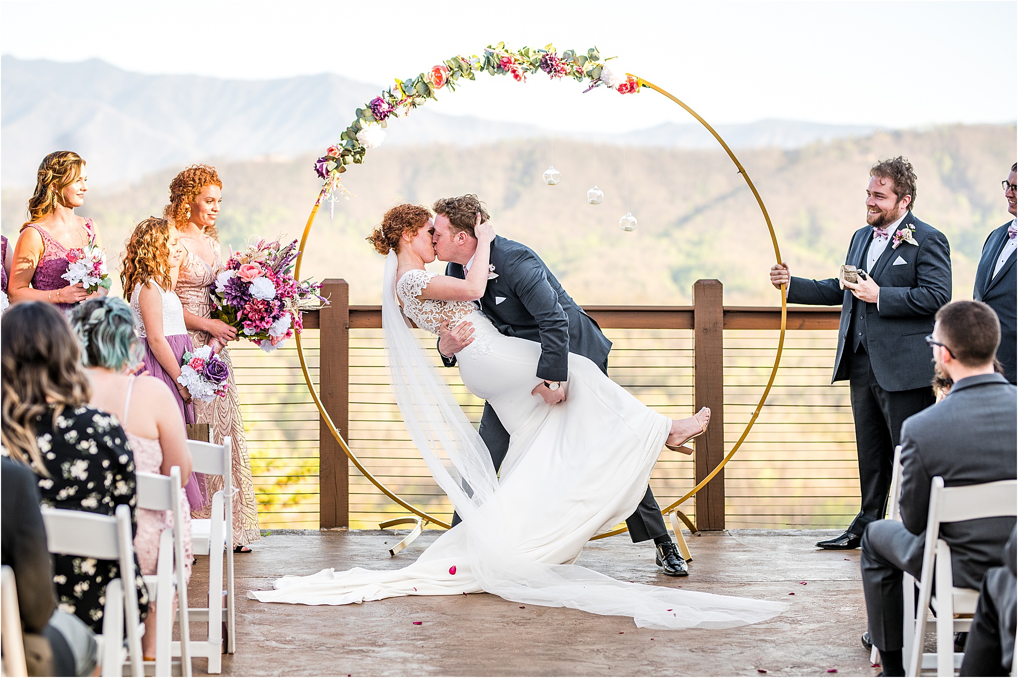 first kiss at wedding ceremony in the mountains