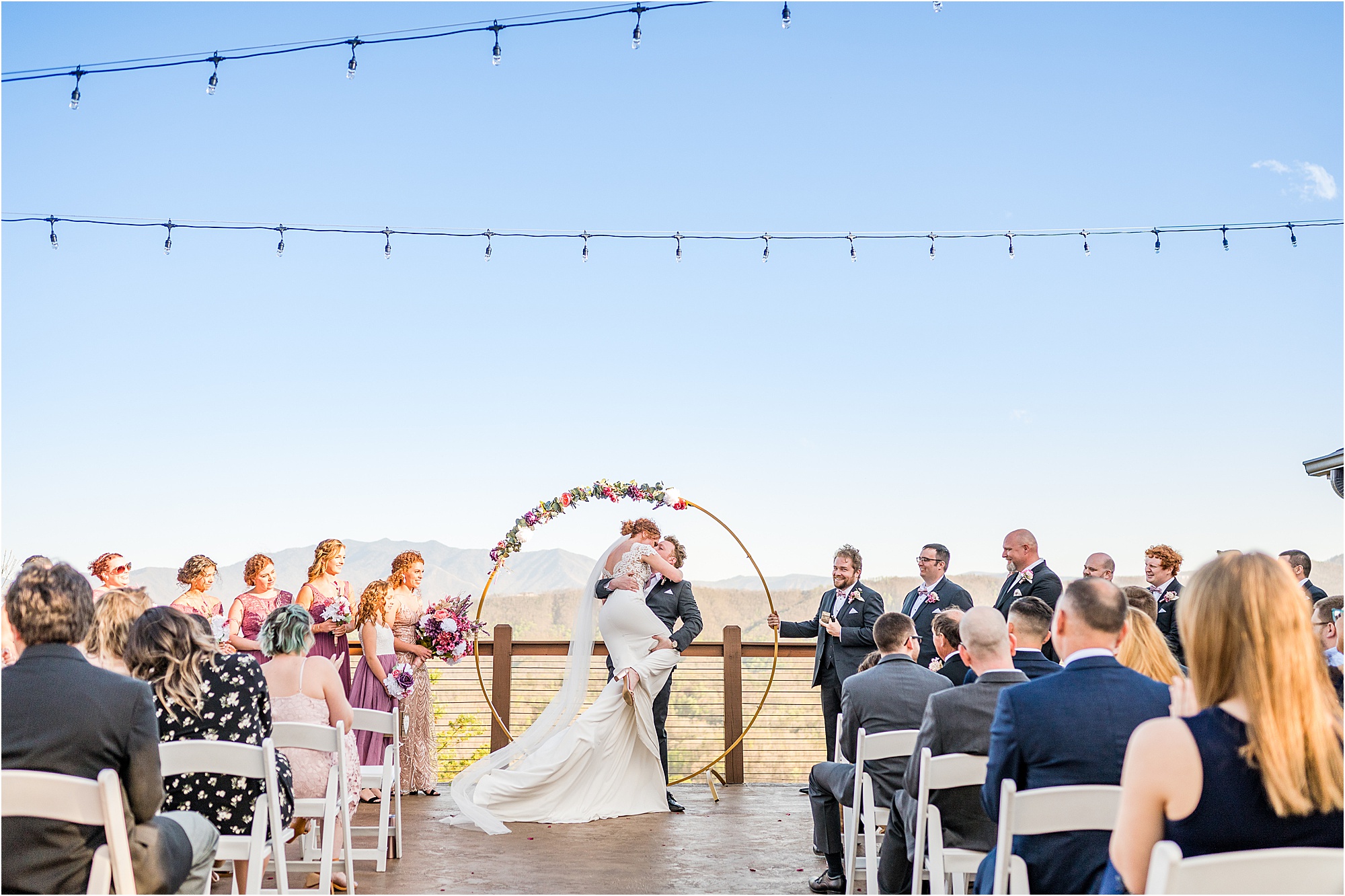 bride umps into grooms arms during first kiss at Eclectic Wedding