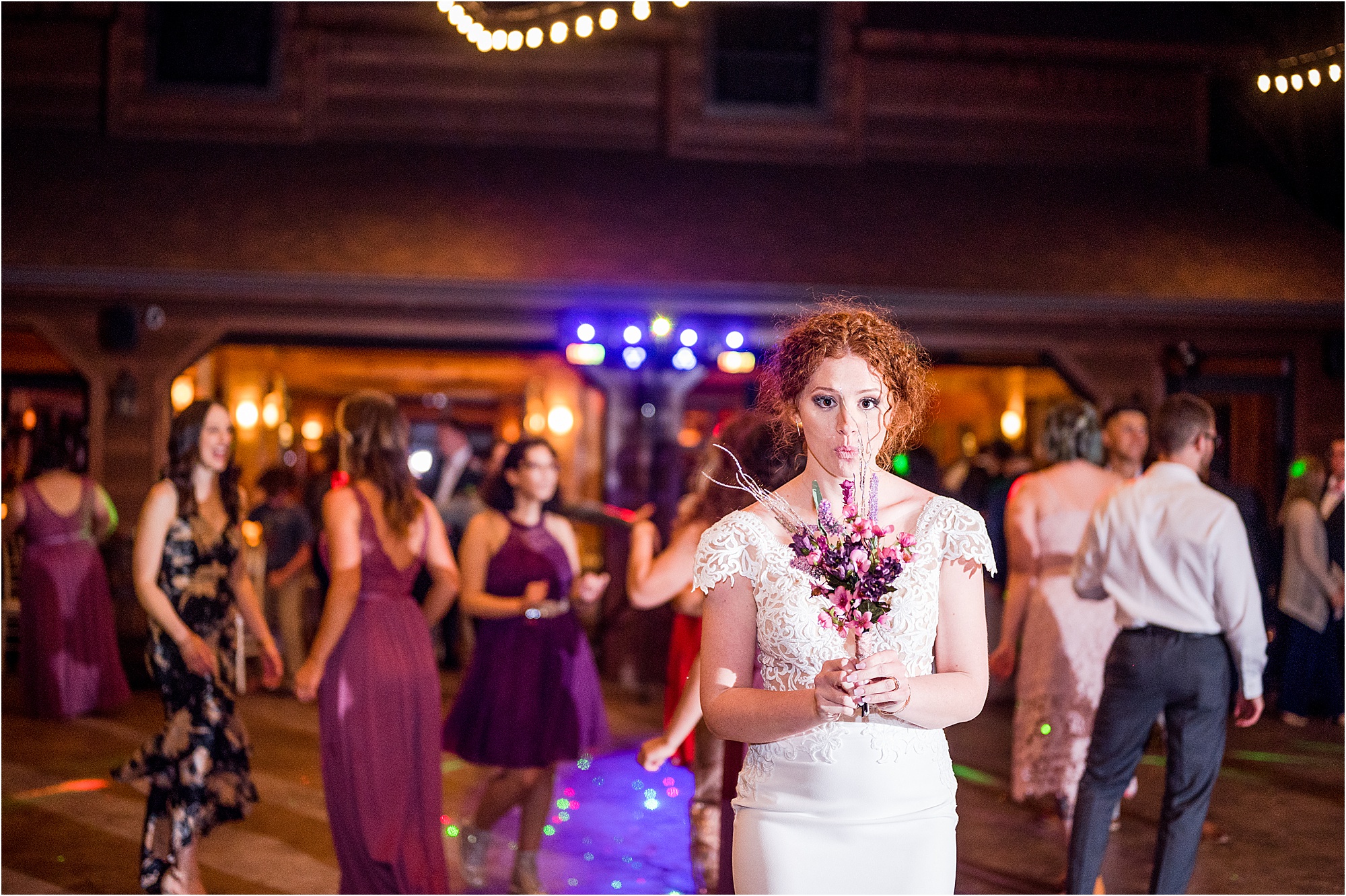 bride tosses bouquet into bridesmaids