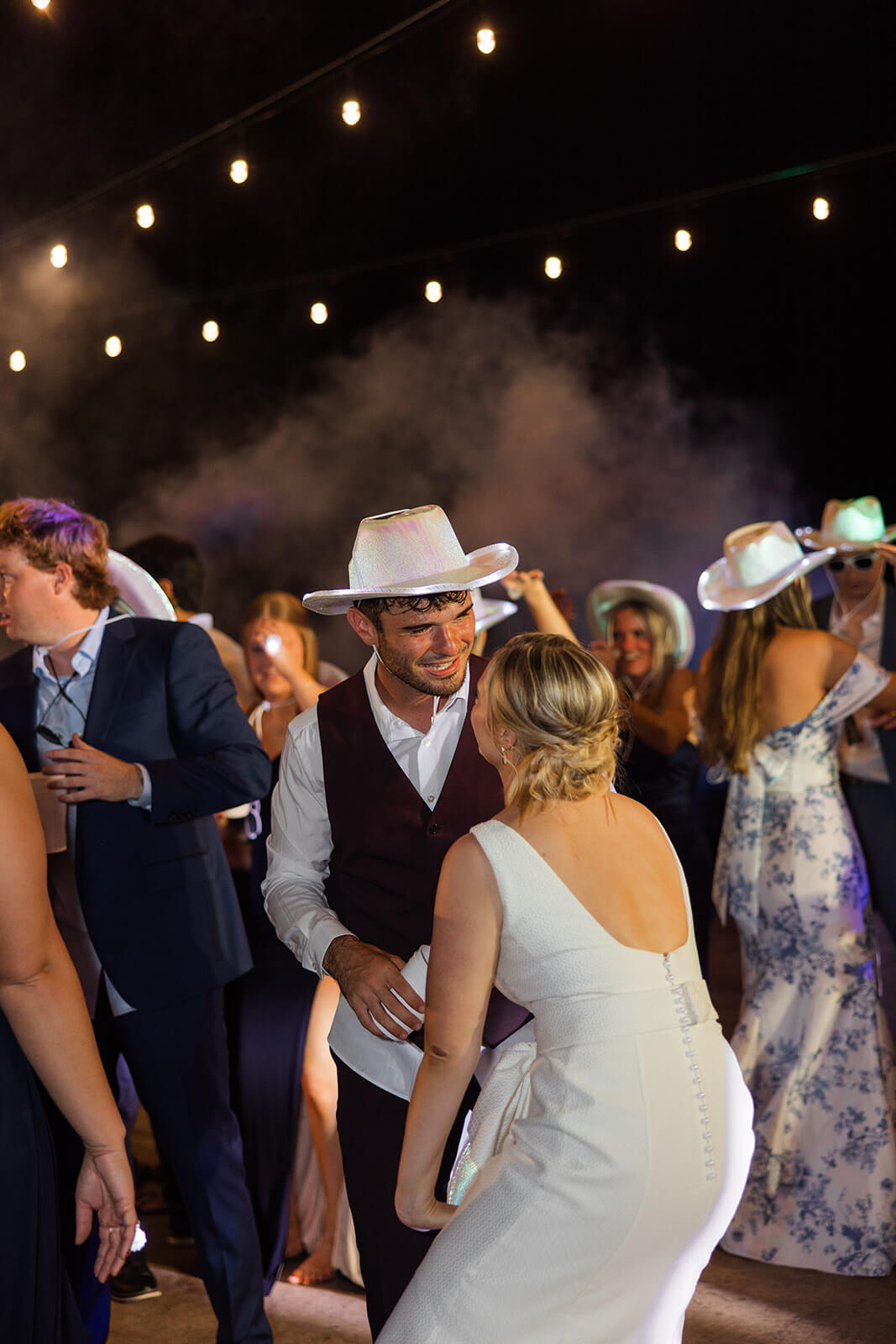 Evening reception under twinkling lights on the dance floor at The Magnolia Venue, a luxury Smoky Mountain wedding venue