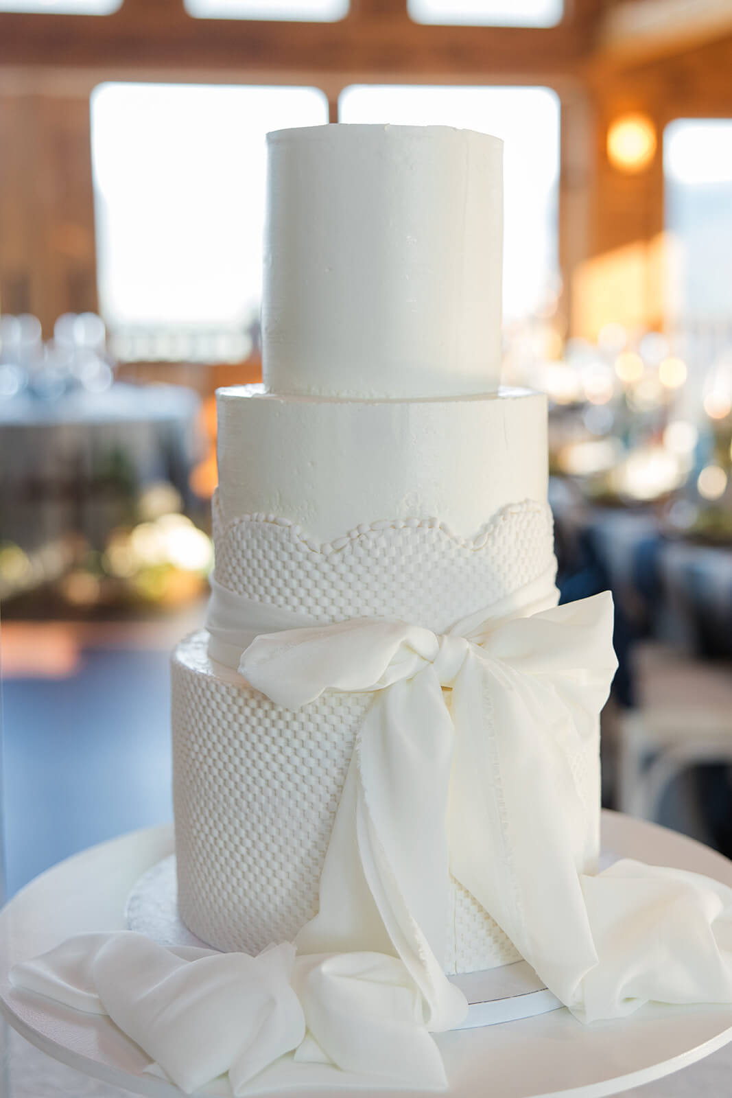 Three-tier wedding cake and monogrammed dance floor inside The Magnolia Venue’s Grand Hall