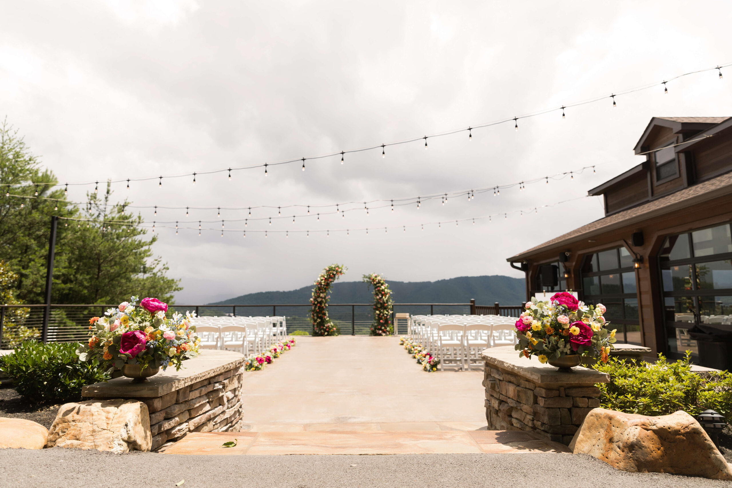 Smoky Mountain Wedding Venue Ceremony patio in the summer with floral arch